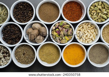 large collection of different spices and herbs isolated on dark background