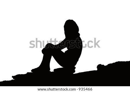 Silhouette of a Female sitting on a rocky slope