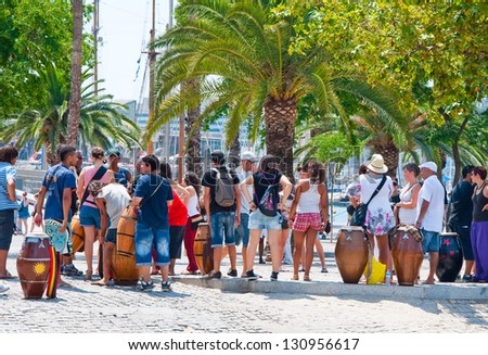 BARCELONA-JULY 25: Group of people listen to music on July 25, 2012 in Barcelona. Barcelona is the capital of Catalonia and the second largest city in Spain with a population of 1,621,537.