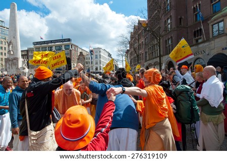 AMSTERDAM,NETHERLANDS-APRIL 27: Locals and tourists in orange clothes celebrate King\'s Day on April 27,2015 in Amsterdam.  King\'s Day is the largest open-air festivity in Amsterdam, the Netherlands.