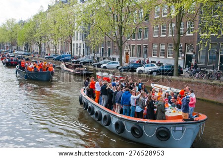 AMSTERDAM,NETHERLANDS-APRIL 27:  Boat party during King\'s Day on April 27,2015 in Amsterdam.  King\'s Day is the largest open-air festivity in Amsterdam.