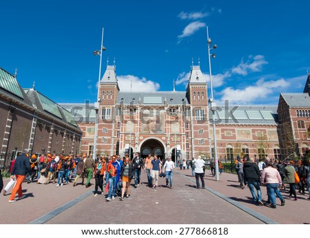 AMSTERDAM-APRIL 27: The Rijksmuseum on King\'s Day people walk to a public space (Museumplein)  on April 27, 2015. The Rijksmuseum is a Netherlands national museum dedicated to arts and history.