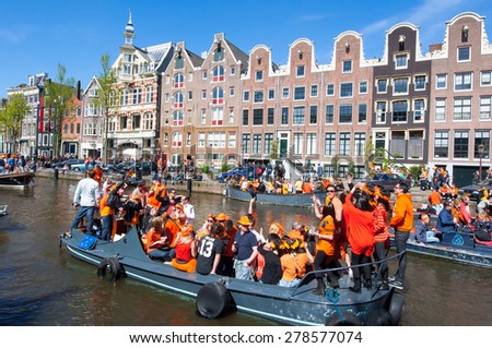 AMSTERDAM-APRIL 27: Crowd of people  participate in celebrating King\'s Day on April 27,2015 the Netherlands. King\'s Day is the largest open-air festivity in Amsterdam.