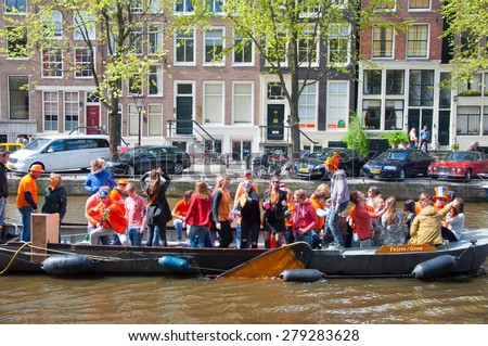 AMSTERDAM-APRIL 27:  King's Day boating, locals have fun on the boats on April 27, 2015 in Amsterdam, the Netherlands. King's Day (Koningsdag) is held on 27 April every year.