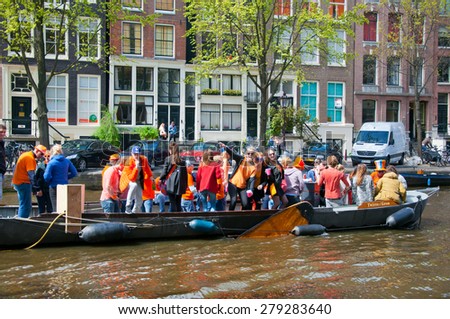 AMSTERDAM-APRIL 27:  King\'s Day boating, people have fun on the boats on April 27, 2015 in Amsterdam, the Netherlands. King\'s Day (Koningsdag) is held on 27 April (the king\'s birthday) every year.