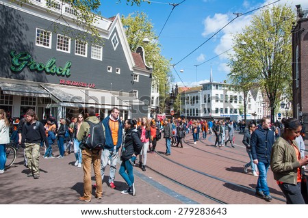 AMSTERDAM-APRIL 27: Crowd of people during King\'s Day on Amsterdam street on April 27,2015.  King\'s Day (Koningsdag) is held on 27 April (the king\'s birthday) every year.