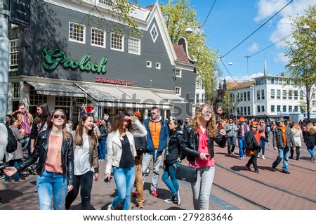 AMSTERDAM-APRIL 27: Young people celebrate the King\'s Day on Amsterdam street on April 27,2015, the Netherlands. King\'s Day (Koningsdag) is held on 27 April (the king\'s birthday) every year.