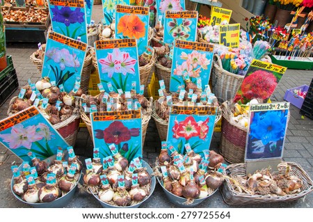 AMSTERDAM-APRIL 28: Shop inside a row of floating barges offers bulbs on the Amsterdam Flower Market on April 28,2015.The Flower market is one of Amsterdam most colourful attractions.
