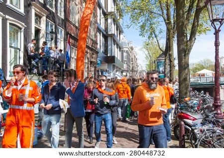 AMSTERDAM-APRIL 27: Locals and tourists celebrate King\'s Day in red-light district on April 27,2015, the Netherlands. King\'s Day is the largest open-air festivity in Amsterdam.