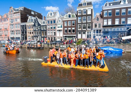 AMSTERDAM-APRIL 27: Happy People in orange celebrate King\'s Day along the Singel canal on the raft on April 27,2015. King\'s Day is the biggest festival celebrating the birth of Dutch royalty.