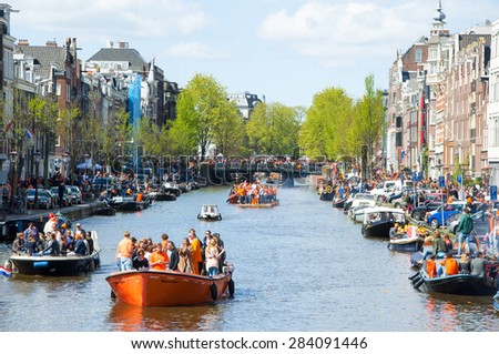 AMSTERDAM-APRIL 27: Amsterdam Singel canal full of boats on King\'s Day on April 27,2015. King\'s Day is the biggest festival celebrating the birth of Dutch royalty.