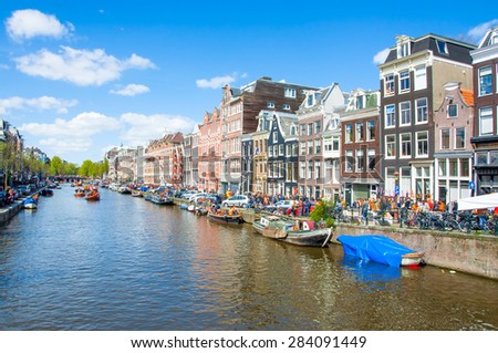 AMSTERDAM-APRIL 27: Amsterdam cityscape on King\'s Day, on April 27,2015, the Netherlands. King\'s Day is the biggest festival celebrating the birth of Dutch royalty.