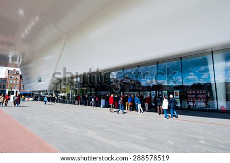 AMSTERDAM-APRIL 30: Tourists stand in queue for Stedelijk Museum on April 30,2015, the Netherlands. Stedelijk is a museum for modern art, contemporary art, and design.