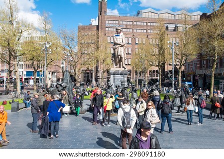 Amsterdam-April 30: Rembrandtplein with a bronze-cast representation The Night Watch, by Mikhail Dronov and Alexander Taratynov, tourists see the sights on April 30, 2015, the Netherlands.