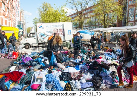 Amsterdam-April 30: Unidentified  people buy clothes in a sale on daily Flea market, Waterlooplein (Waterloo Square) on April 30,2015, the Netherlands.