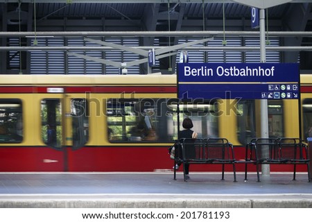 BERLIN, GERMANY - JUNE 17: A platform of the Berlin East Railway station with a waiting traveler and a tram on June 17, 2014 in Berlin / Platform Berlin Railway Station