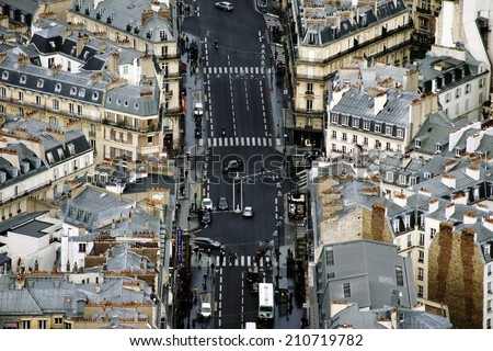 PARIS, FRANCE - DECEMBER 31: The aerial view of a main road with road transport, a bus stop and pedestrians on December 31, 2013 in Paris / Paris traffic