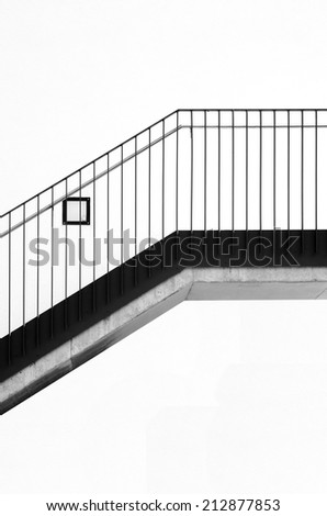The photograph of a modern staircase with a railing made of stainless steel / Modern staircase