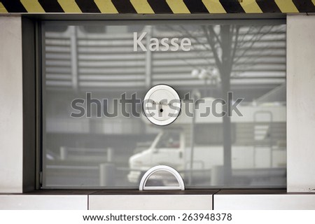 A ticket booth with reflections in the window where they ticket sell / Ticket booth with switch box