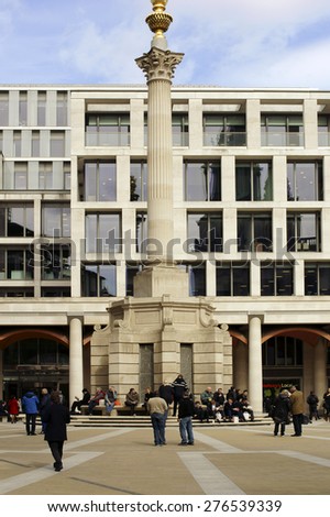 LONDON, UK - APRIL 01:  People and passers sit and go before the memorial column to the Great Fire in London, the Monument on April 01, 2015 in London / Memorial column to the Great Fire London