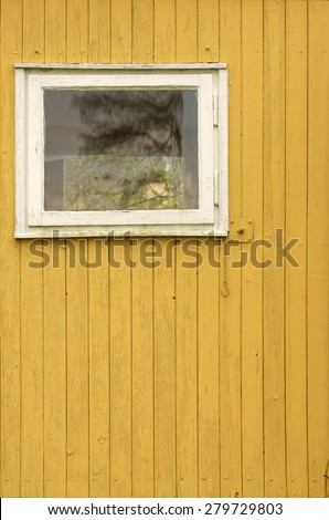 The wooden wall of a garden shed with a window / Wooden wall with window