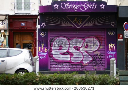 PARIS, FRANCE - JANUARY 01: A closed and with graffiti colorfully painted strip club on the famous boulevard de Clichy on January 01, 2014 in Paris / Strip club