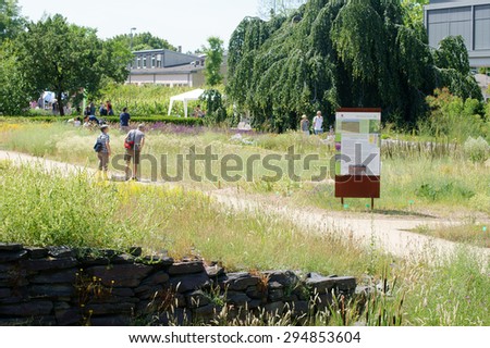 MAINZ, GERMANY - JUNE 14: Flower lovers consider flowerbeds at the summer festival of the Botanical Garden of the University of Mainz on June 14, 2015 in Mainz / Summer Festival