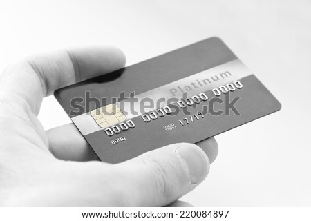 closeup of  credit card holded by hand. Black and white picture