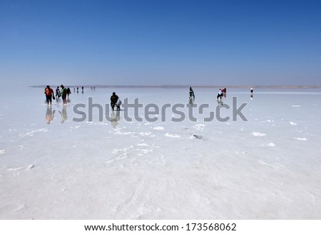 SALT LAKE, TURKEY - JULY 03: People walking at Salt Lake on July 03, 2013 in Aksaray, Turkey. Salt Lake is the second largest lake in Turkey