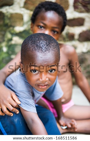 GHANA - MARCH 2, 2012: Ghanaian little boy gives a hug to his brother in Ghana, on March 2nd, 2012. People in Ghana suffer from poverty due to the slow development of the country