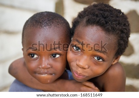 GHANA - MARCH 2, 2012: Ghanaian little boy gives a hug to his brother in Ghana, on March 2nd, 2012. People in Ghana suffer from poverty due to the slow development of the country