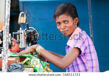GHANA - MARCH 2, 2012: Unidentified Ghanaian woman works with a sewing machine in Ghana, on March 2nd, 2012. People in Ghana suffer from poverty due to the slow development of the country
