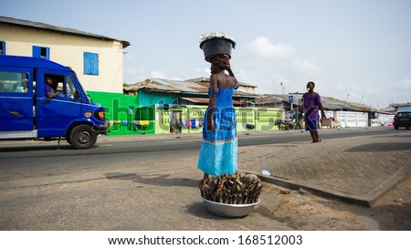 GHANA - MARCH 2, 2012: Unidentified Ghanaian woman sells fish near the road in Ghana, on March 2nd, 2012. People in Ghana suffer from poverty due to the slow development of the country