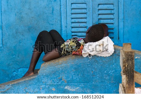 GHANA - MARCH 2, 2012: Unidentified Ghanaian woman takes a nap after the hard work in Ghana, on March 2nd, 2012. People in Ghana suffer from poverty due to the slow development of the country