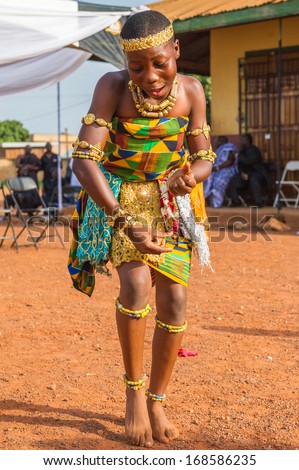 GHANA - MARCH 3, 2012: Unidentified Ghanaian girl in national colors clothes  dances the traditional African dance in Ghana, on March 3rd, 2012. Music is the main kind of entertainment in Africa
