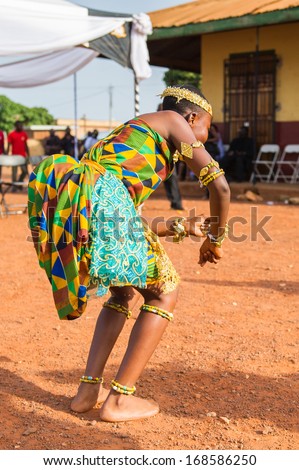 GHANA - MARCH 3, 2012: Unidentified Ghanaian girl in national colors clothes  dances the traditional African dance in Ghana, on March 3rd, 2012. Music is the main kind of entertainment in Africa