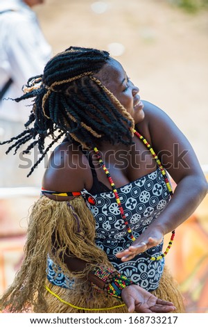 ANGOLA, LUANDA - MARCH 4, 2013:  Angolan sympathetic woman dances the national folk dance in Angola, Mar 4, 2013. Music is one of the main African entertainments.