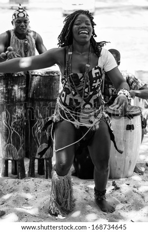 ANGOLA, LUANDA - MARCH 4, 2013:  Angolan beautiful woman dances the national folk dance in black and white in Angola, Mar 4, 2013. Music is one of the main African entertainments.