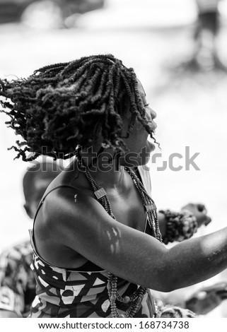 ANGOLA, LUANDA - MARCH 4, 2013:  Angolan beautiful woman dances the national folk dance in black and white in Angola, Mar 4, 2013. Music is one of the main African entertainments.