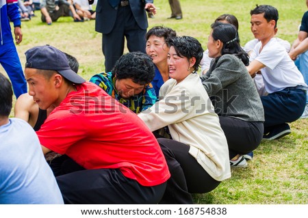 NORTH KOREA - MAY 1, 2012: Korean women actively participate in the tug of war game during the celebration of the  Worker\'s Day in N.Korea, May 1, 2012. May 1 is a national holiday in 80 countries