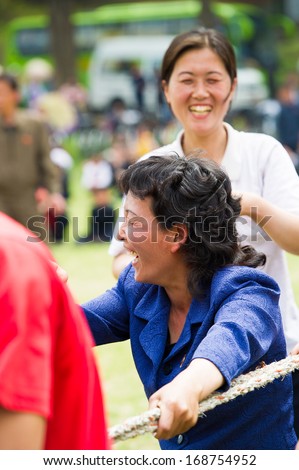 NORTH KOREA - MAY 1, 2012: Korean women actively participate in the tug of war game during the celebration of the  Worker's Day in N.Korea, May 1, 2012. May 1 is a national holiday in 80 countries