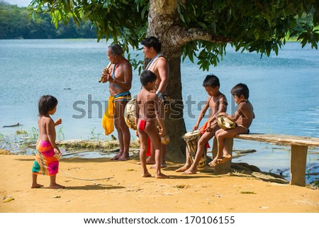 EMBERA VILLAGE, PANAMA, JANUARY 9, 2012: Unidentified native Indian family make music for tourists  in Panama, Jan 9, 2012. Indian reservation is the way to conserve native culture
