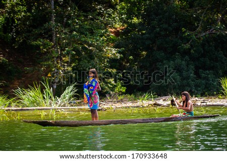 EMBERA VILLAGE, PANAMA, JANUARY 9, 2012: Two unidentified native Indian girls in a boat in Panama, Jan 9, 2012. Embera village is the Indian reservation in Panama