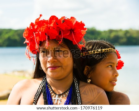 EMBERA VILLAGE, PANAMA, JANUARY 9, 2012: Portrait of an unidentified native Indian woman and her daughter in Panama, Jan 9, 2012. Indian reservation is the way to conserve native culture, languange