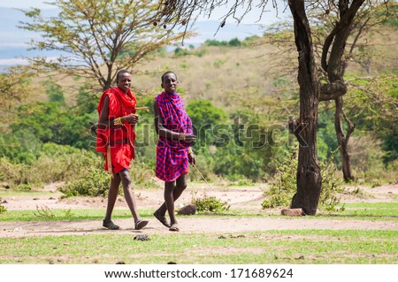 AMBOSELI, KENYA - OCTOBER 10, 2009: Two unidentified Massai people walk and talk in Kenya, Oct 10, 2009. Massai people are a Nilotic ethnic group