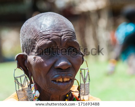 AMBOSELI, KENYA - OCTOBER 10, 2009: Portrait of an unidentified Massai extraordinary woman with heavy earings in Kenya, Oct 10, 2009. Massai people are a Nilotic ethnic group