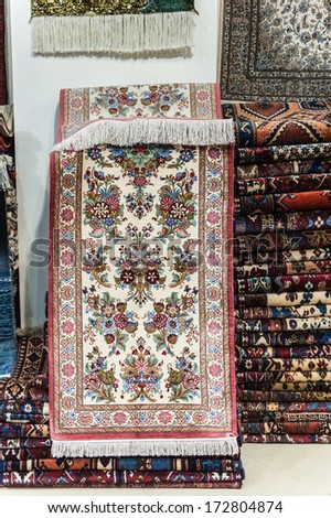 ISFAHAN, IRAN - JAN 7, 2014: Persian carpet on the wall of a shop in Iran, Jan 7, 2014. Persian carpet is an important part of Persian art and culture.
