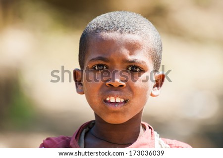 AKSUM, ETHIOPIA - SEP 28, 2011: Portrait of an unidentified Ethiopian cute little boy in old clothes in Ethiopia, Sep.28, 2011. People in Ethiopia suffer of poverty due to the unstable situation