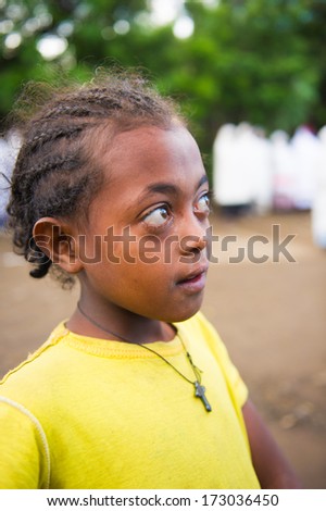 AKSUM, ETHIOPIA - SEP 27, 2011: Portrait of an unidentified Ethiopian cute girl in a yellow shirt in Ethiopia, Sep.27, 2011. Children in Ethiopia suffer of poverty due to the unstable situation