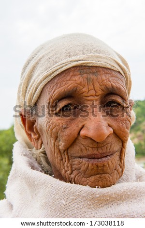 AKSUM, ETHIOPIA - SEP 24, 2011: Unidentified Ethiopian old woman in white clothes in Ethiopia, Sep.24, 2011. People in Ethiopia suffer of poverty due to the unstable situation